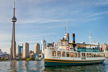 Water view of a boat tour with a skyline in the background.