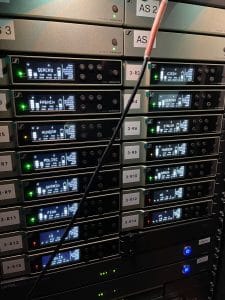Professional audio rack showing audio sources labeled with the language (i.e. German, French, Hungar, and Czech) with Listen EVERYWHERE servers at the bottom of the rack.